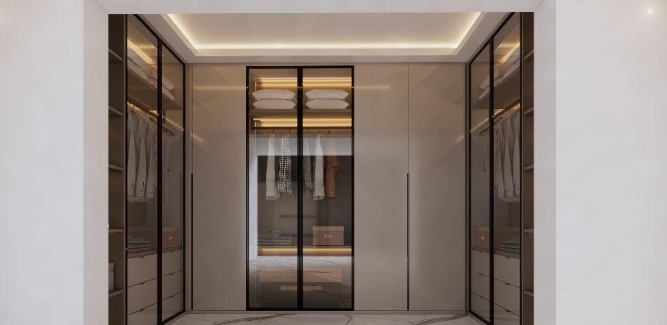Walk-in wardrobe design with black-framed glass doors, lit hanging space and warm grey panelled doors