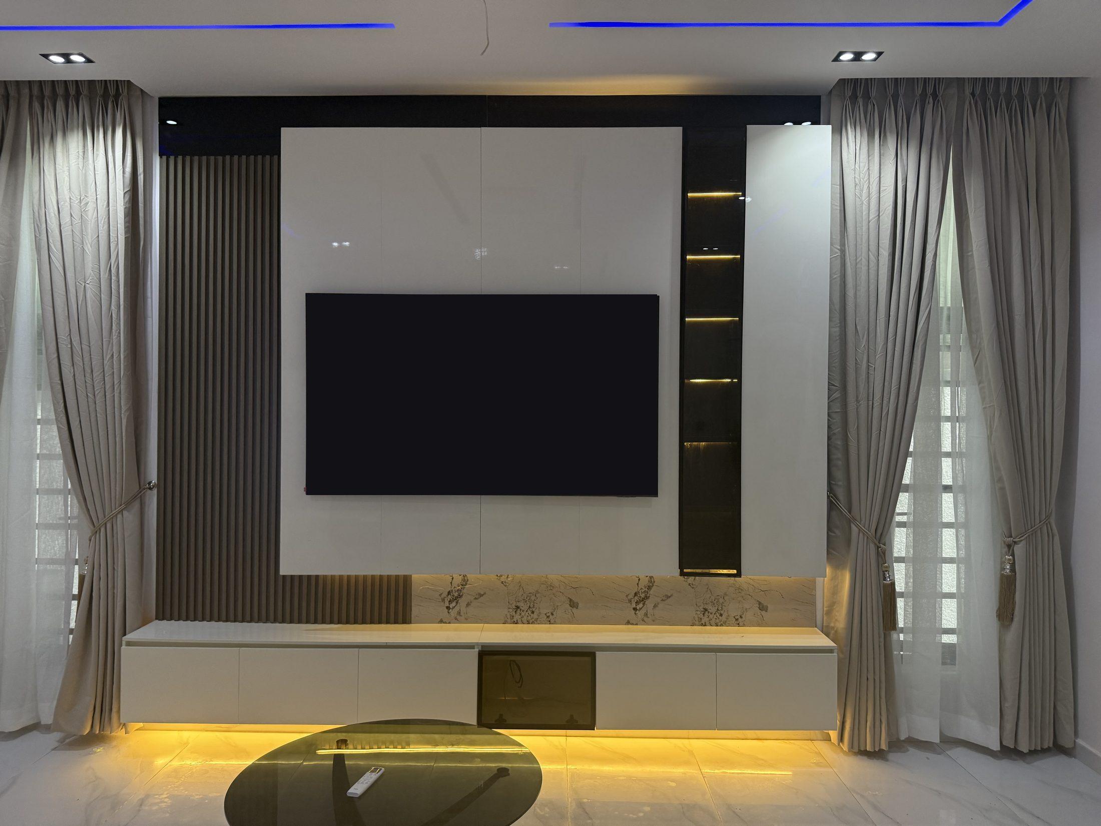 Front view of a white gloss media wall with a wall-mounted TV, slatted timber panel, lit glass niche and warm light beneath a floating unit